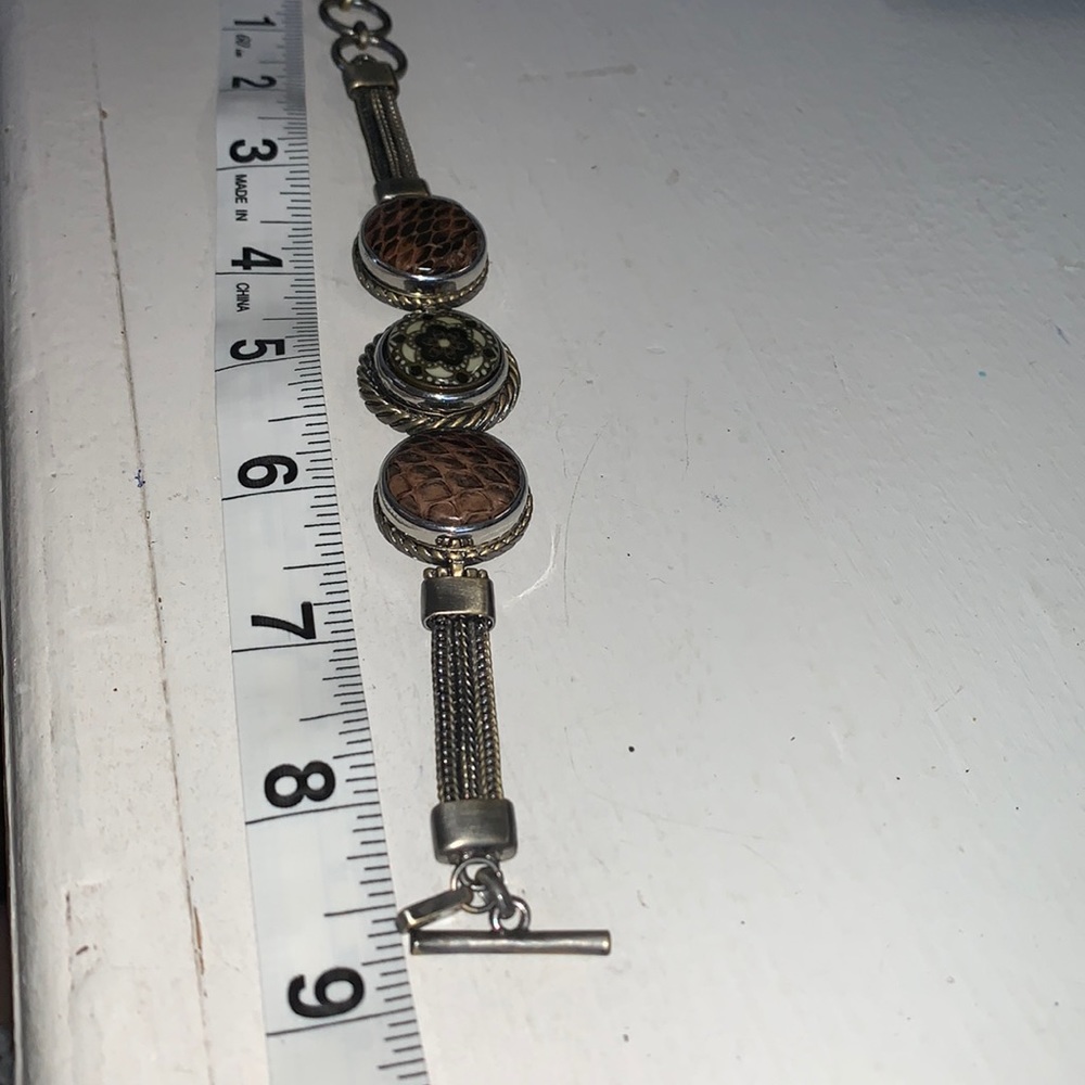 6.5”-8.5” antique brass finish bracelet with 3 snaps, toggle close.  NWOT